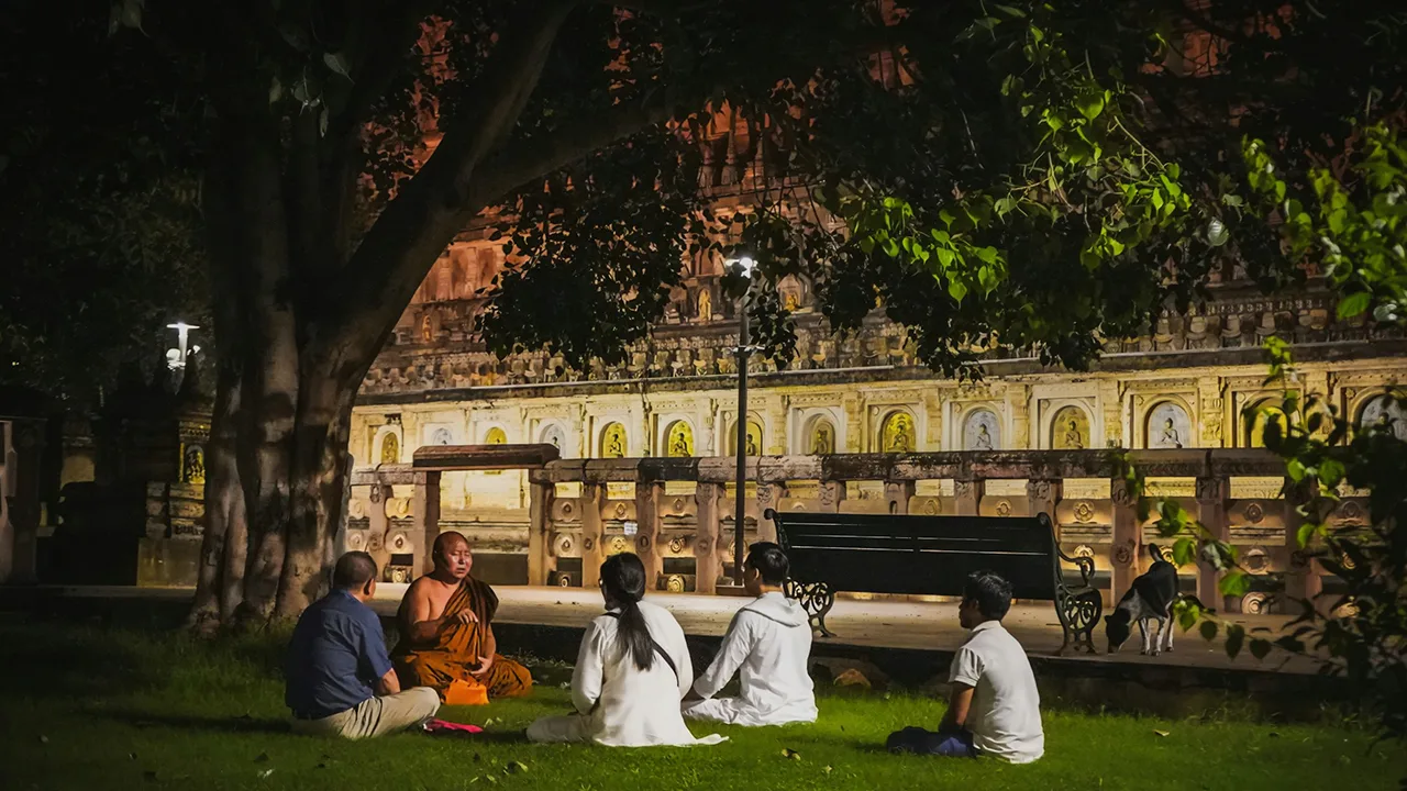 Buddhist monk giving teachings in garden at Bodh Gaya