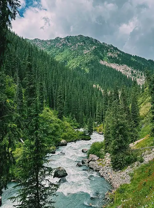 Nature tourism across Kyrgyzstan featuring alpine lakes mountains and scenic valleys