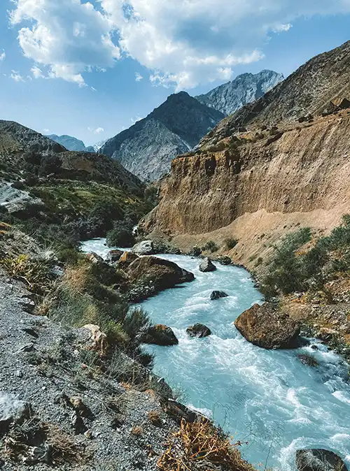 Holiday travel exploring Tajikistan's scenic wilderness, alpine meadows, and peaks