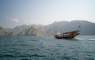 Oman travel package exploring Muscat, Nizwa, Wadi Shab, and Wahiba Sands desert landscapes.
